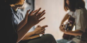 Three People Pray And Praising God Together