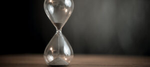 Hourglass On Wooden Background