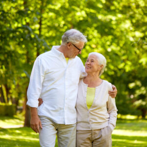 Happy Senior Couple Hugging In City Park
