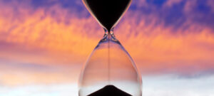 Hourglass On The Background Of A Sunset. The Value Of Time In Life. An Eternity.