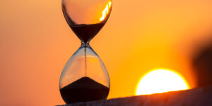 Hourglass On The Background Of A Sunset. The Value Of Time In Li